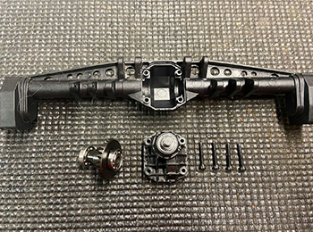 Remove the four screws that attach the third member to the pumpkin
of the axle.